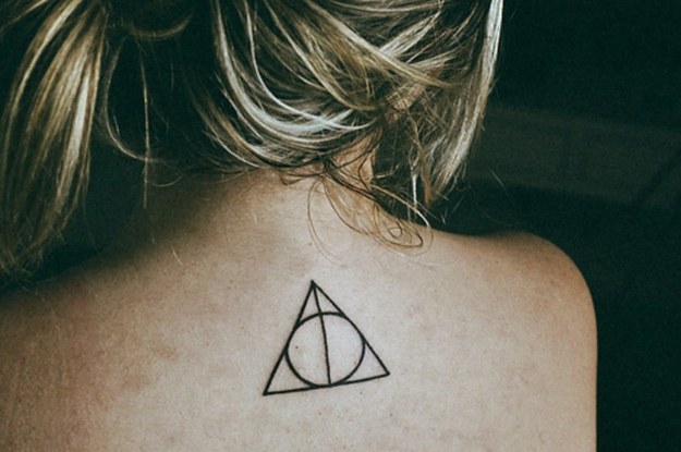 Simple Deathly Hallows Tattoo On Upper Back For Girls