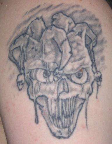 Small Grey Ink Evil Jester Face Tattoo