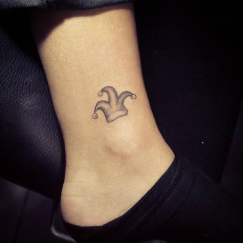 Small Grey Ink Jester Cap Tattoo On Ankle