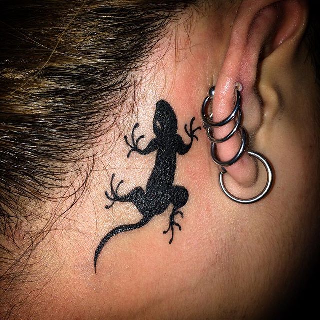 Small Reptile Lizard Silhouette Behind Ear Tattoo
