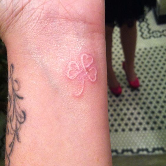 Small White Ink Celtic Shamrock Leaf Tattoo On Wrist