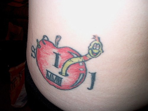Smiling Worm With Roman Numerals On Rotten Apple Tattoo On Hip