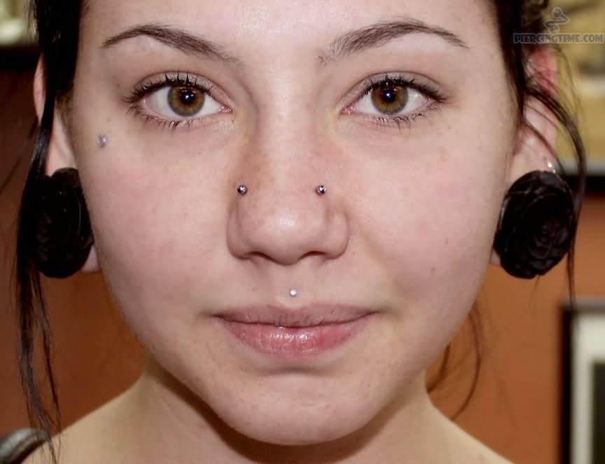 Stretched Lobe And Nostril Piercings