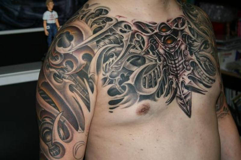 Superb 3D Grey Biomechanical Tattoo On Chest And Shoulders