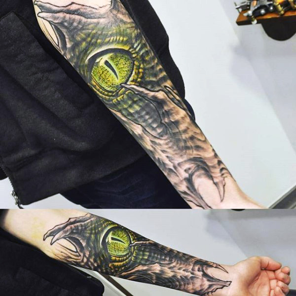 Superb Greenish Reptile Eye Tattoo On Forearm