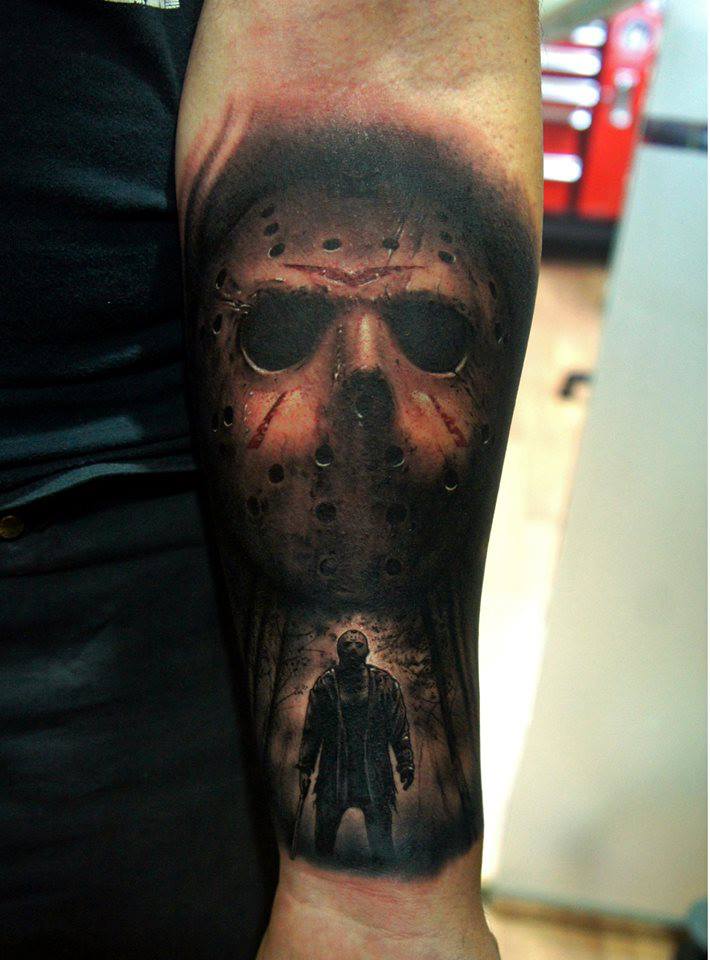 Terrific Grey And Black Jason With Large Mask Tattoo On Forearm