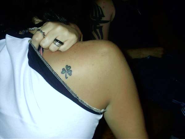Tiny Black Shamrock Tattoo On Left Back Shoulder