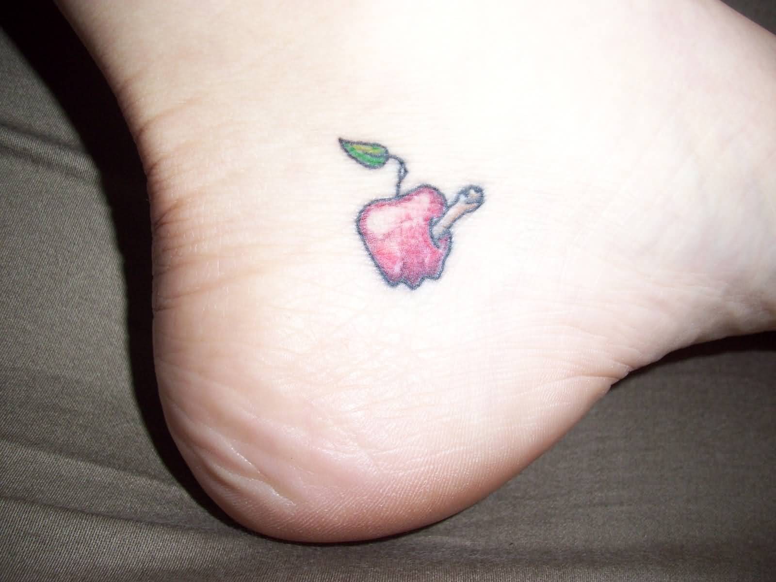 Tiny Cute Worm Half In Rotten Apple Tattoo On Foot