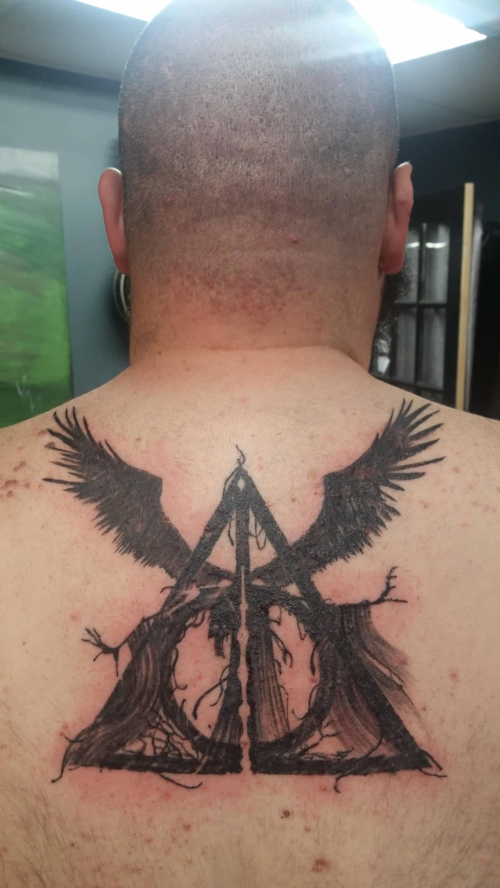 Unique Grey Deathly Hallows Tattoo On Upper Back