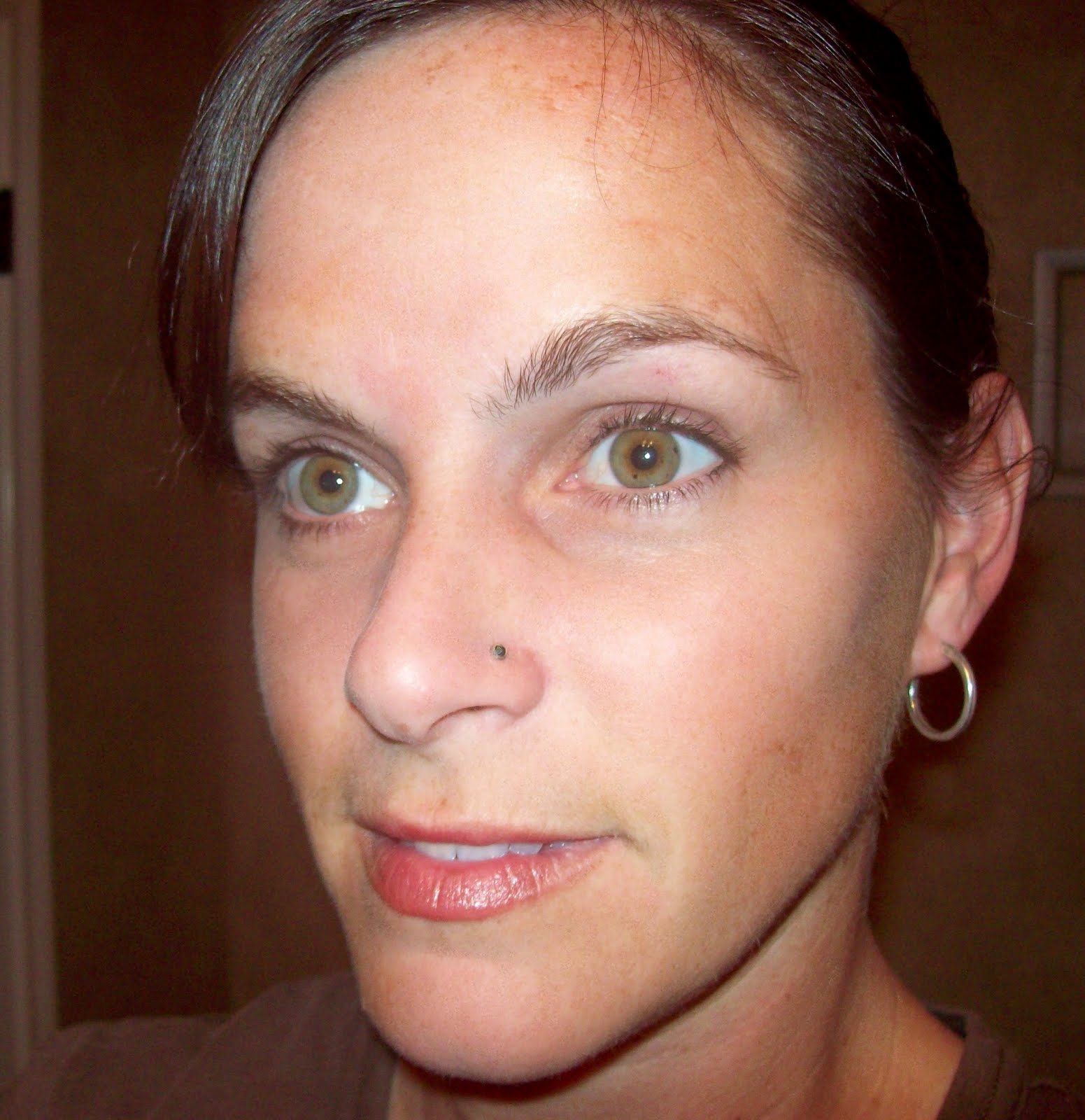 Woman With Left Ear Lobe And Nostril Piercing