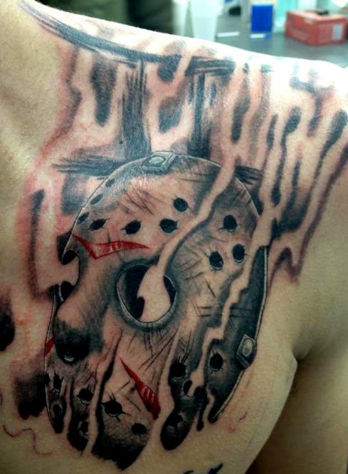 Wonderful Grey Smoke Coming Out Of Jason Mask Tattoo On Left Chest