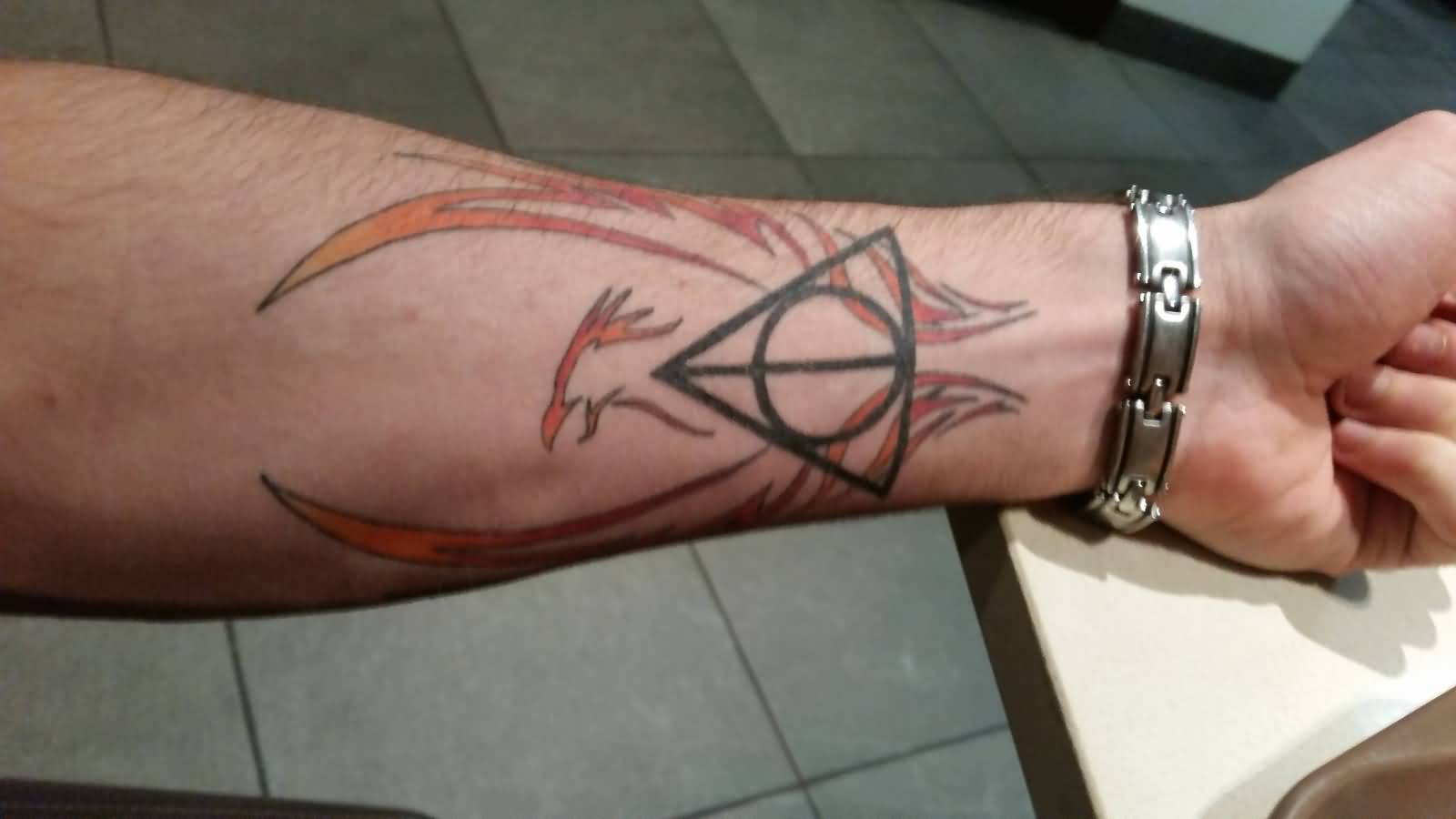 Wonderful Tribal Phoenix Hallows Tattoo On Forearm