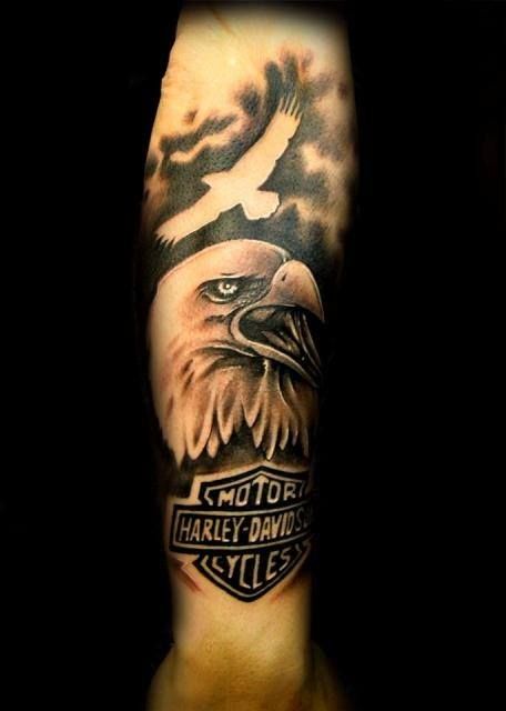 Awesome Eagle And Harley Davidson Logo Tattoo On Forearm
