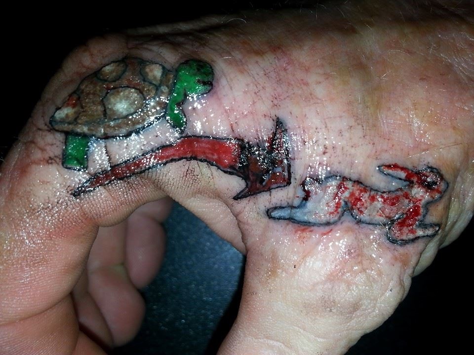 Awful Tortoise And Hare Racing Tattoo On Hand