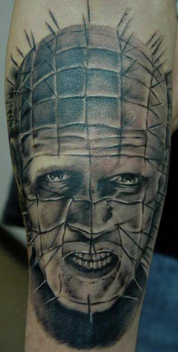 Black And Grey Angry Pinhead Tattoo On Arm