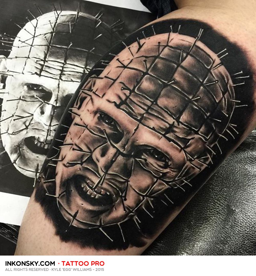 Black And Grey Ink Pinhead Face Tattoo