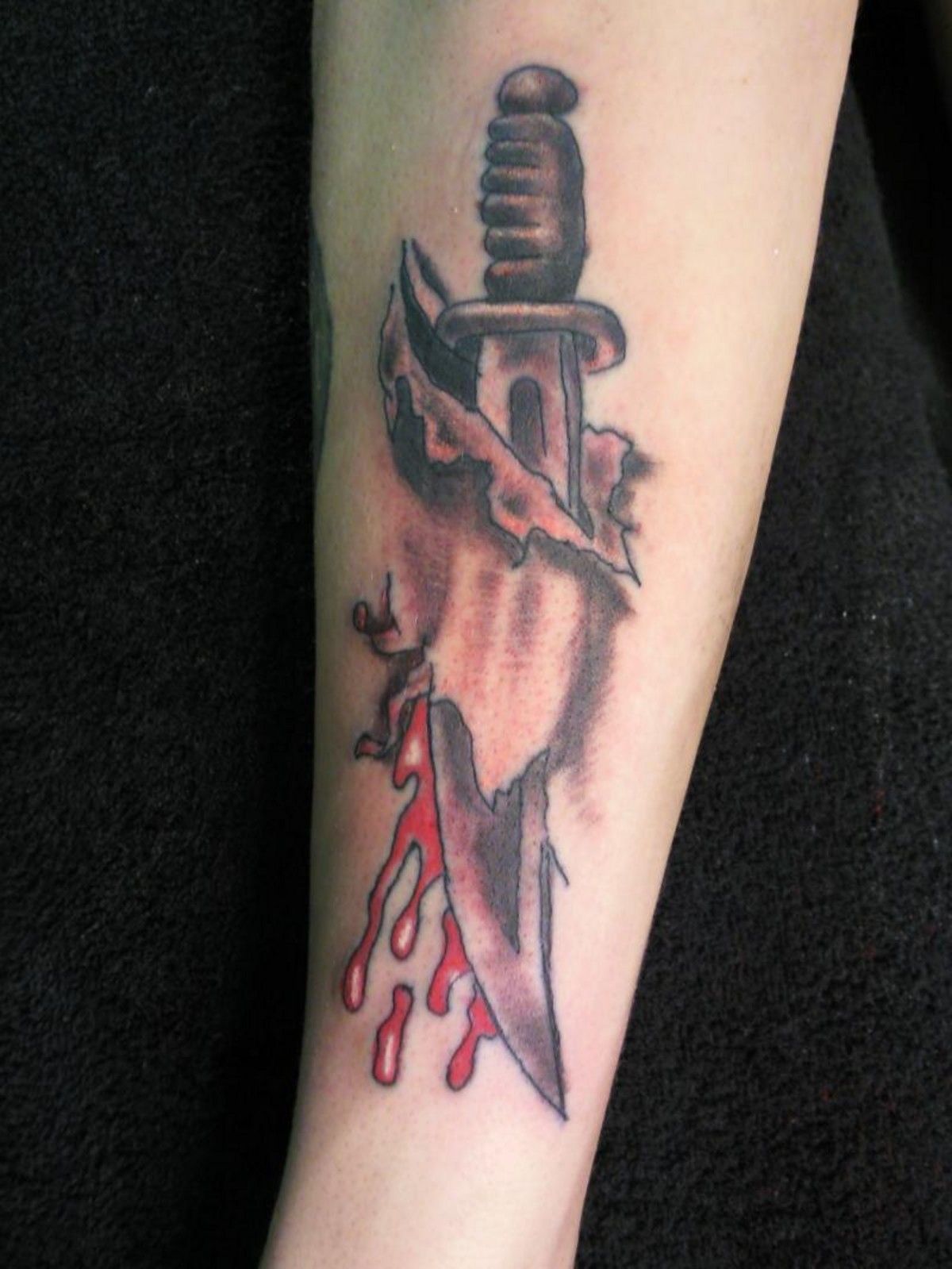 Bleeding Knife 3D Dagger Tattoo On Forearm