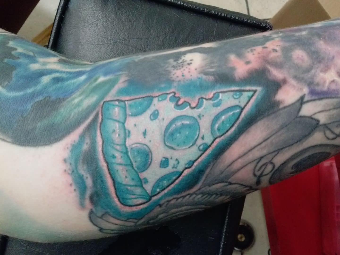 Blue Ink Pizza Slice Tattoo On Arm
