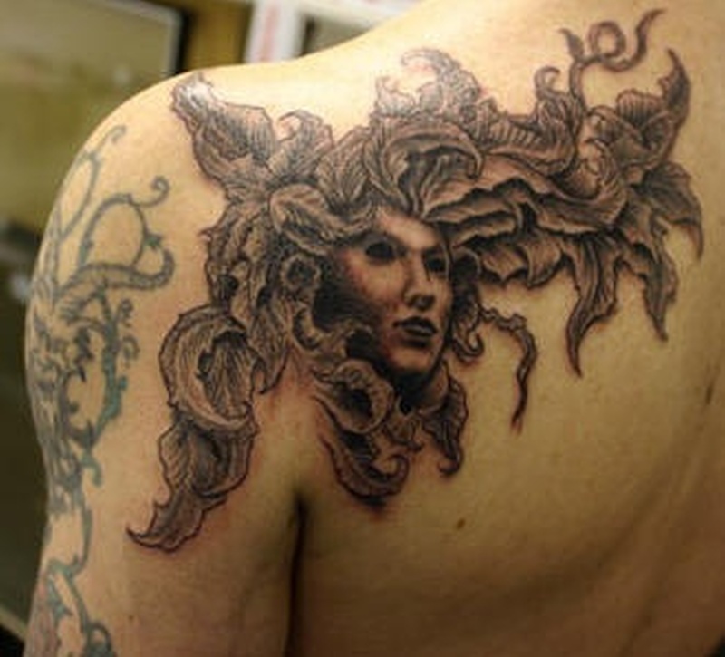 Creative Face With Growing Plants Tattoo On Back Left Shoulder