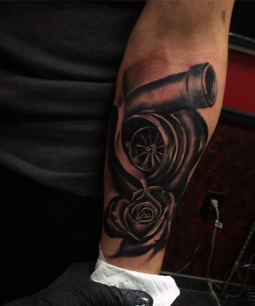 Dark Grey Turbo And Rose Flower Tattoo On Forearm