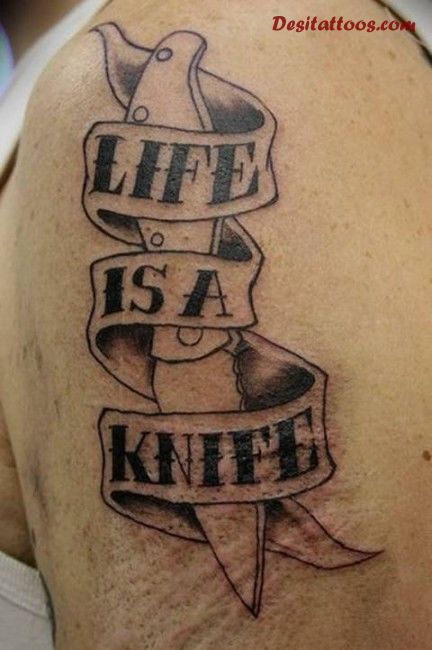 Grey Life Is A Knife Tattoo On Left Shoulder