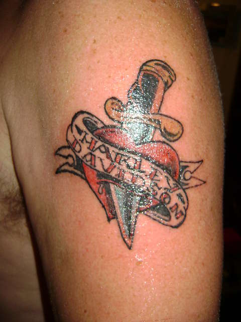 Knife Ripped Heart And Harley Davidson Logo Tattoo