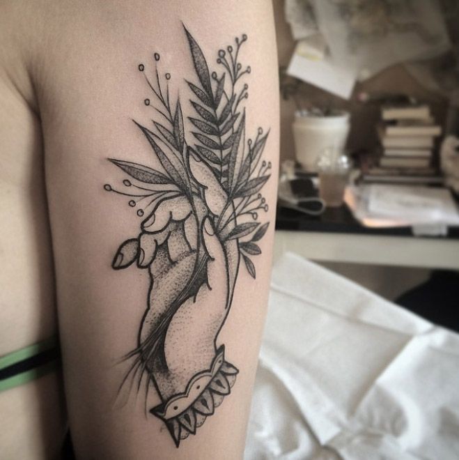Lovely Hand Holding Plant Tattoo On Half Sleeve