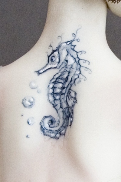 Lovely Small Seahorse Tattoo On Upper Back