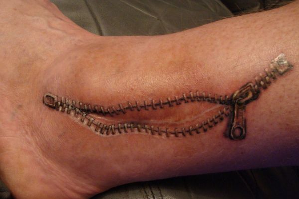 Nice Open Zipper Scar Tattoo On Ankle