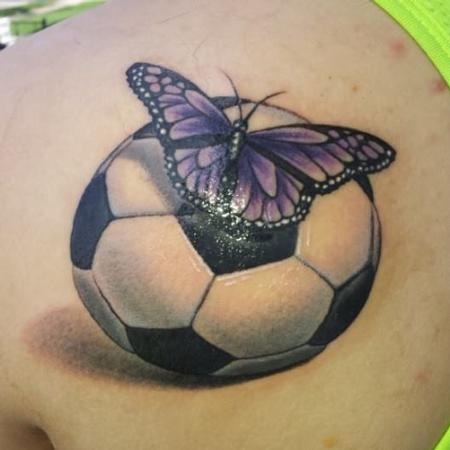 Realistic Butterfly On Football Tattoo On Left Back Shoulder