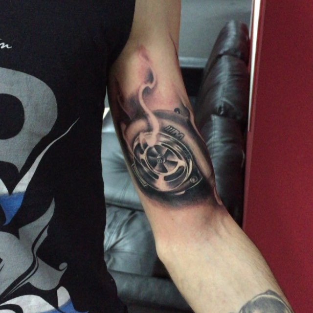 Realistic Grey Turbo Charger Tattoo On Biceps