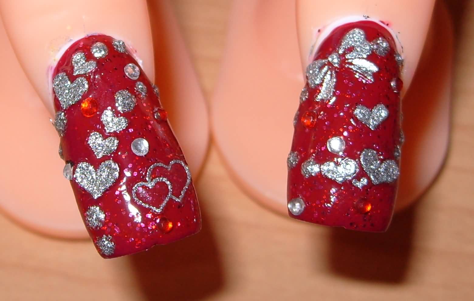 Red Nails With Silver Glitter Hearts And Bow Nail Art