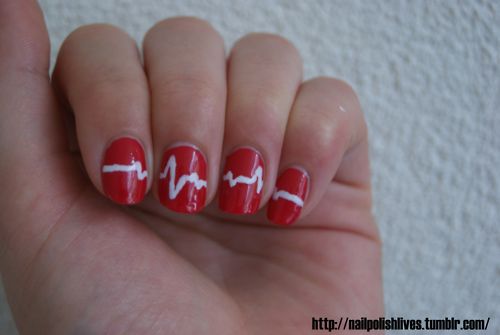Red Nails With White Heartbeat Nail Art