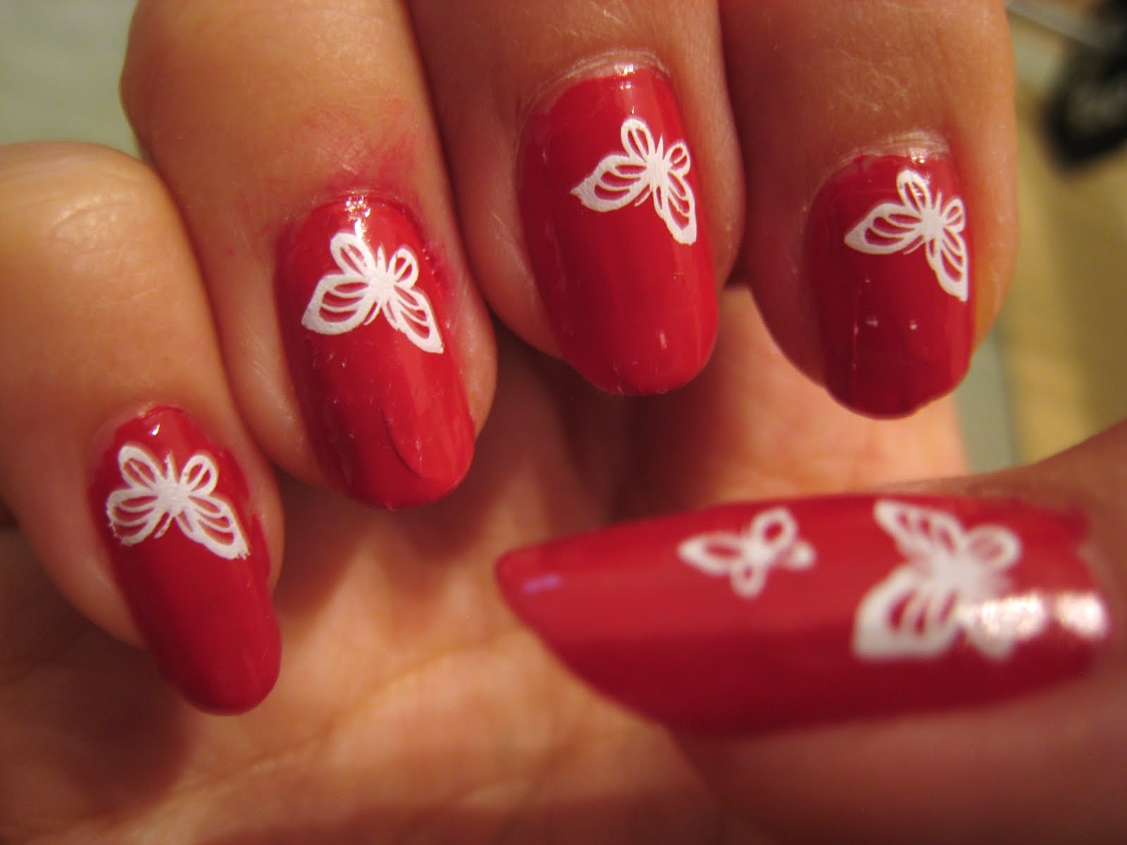 Red Nails With White Butterflies Nail Art