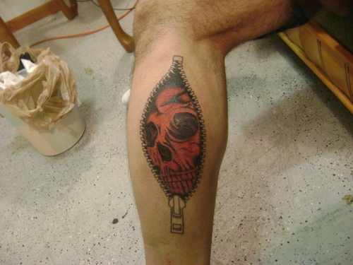Red Skull With Zipper Tattoo On Leg