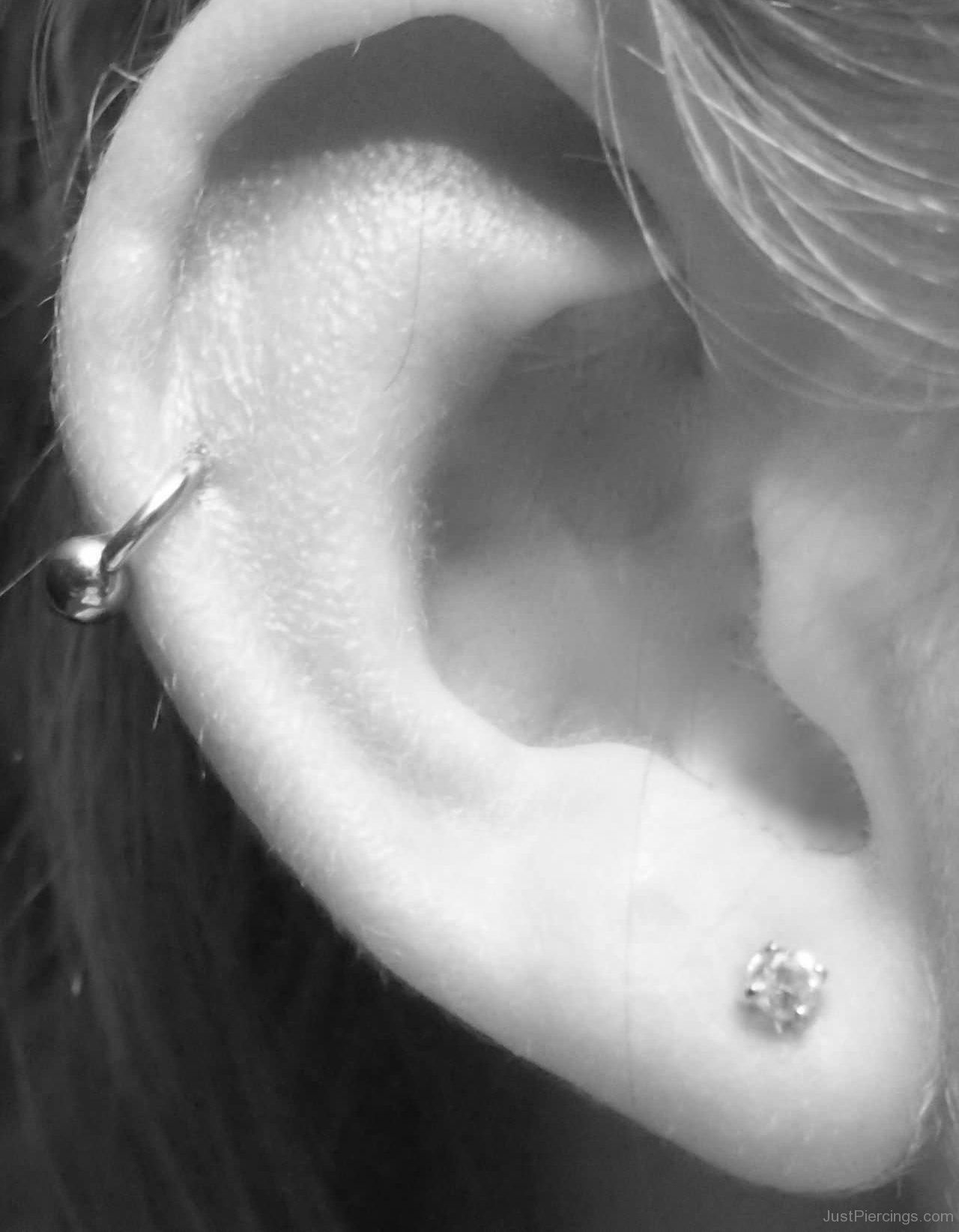 Right Ear Lobe And Rim Piercing With Silver Bead Ring