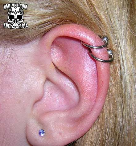 Single Ear Lobe And Rim Piercing With Silver Bead Rings