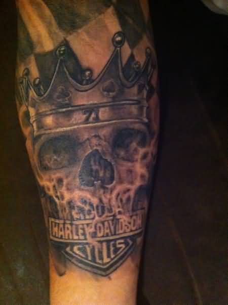 Skull Wearing Crown And Harley Bike Logo Tattoo