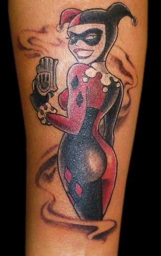 Smiling Harley Quinn With Gun Tattoo On Arm
