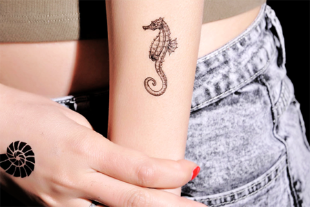 Tiny Seahorse Tattoo On Girl Arm Sleeve
