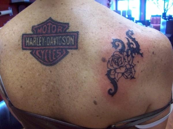 Tribal Rose And Harley Davidson Logo Tattoo On Upper Back