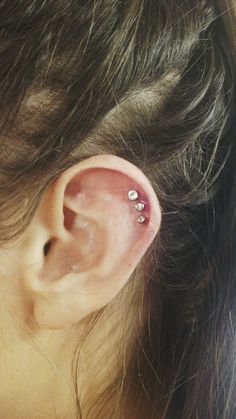 Triple Rim Piercing On Girl Left Ear