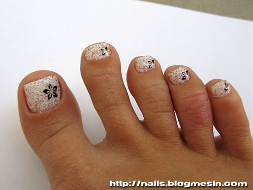 White Glitter Toe Nails With Black Flower Design Idea