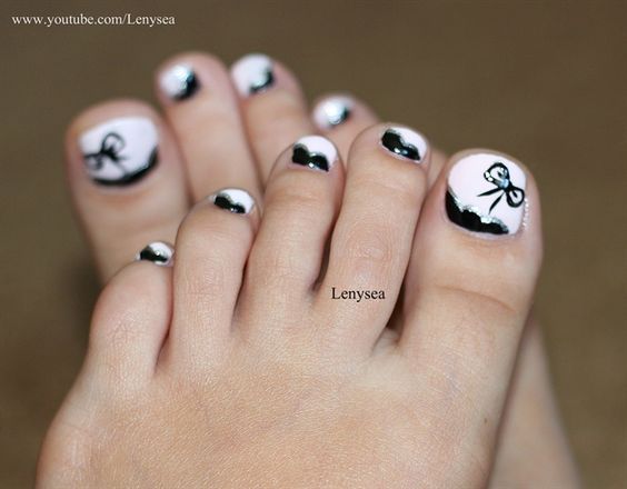 White Toe Nails With Black Bow Design Nail Art