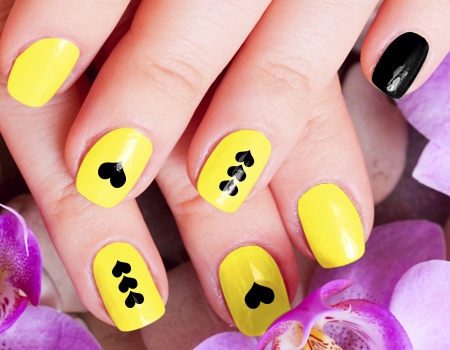 Yellow Nails With Black Hearts Nail Art Idea