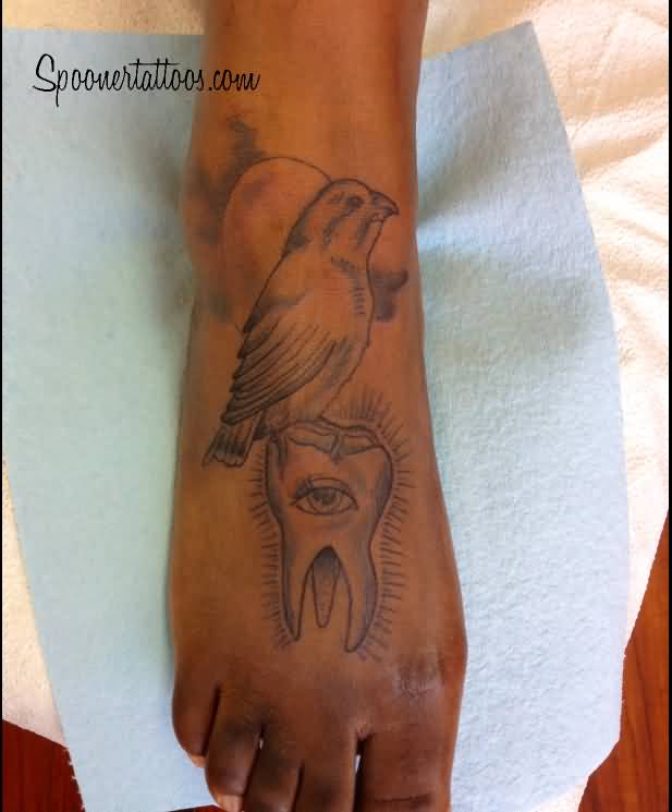 Awesome Bird On Eye Molar Tattoo On Foot
