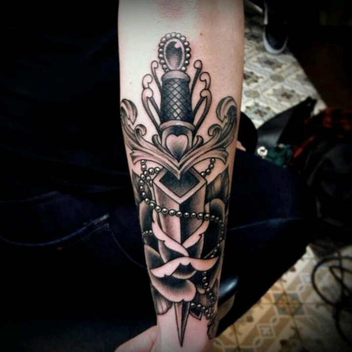 Black And White Dagger Traditional Tattoo On Forearm