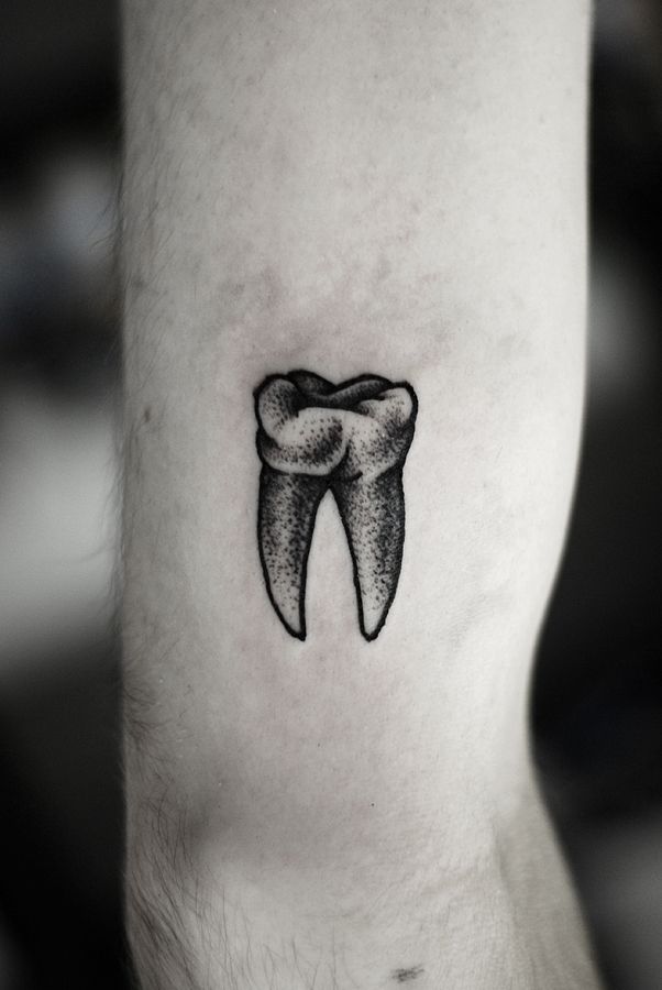 Black And White Molar Tooth Tattoo On Arm