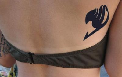 Black Fairy Tail Logo Tattoo On Upper Back