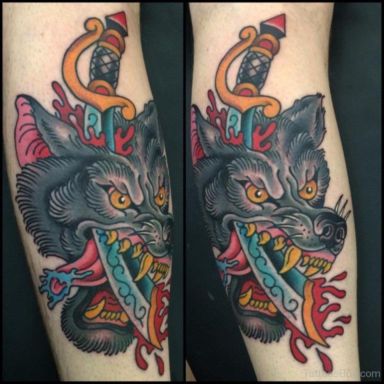 Colored Wolf And Dagger Traditional Tattoo On Arm